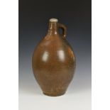 A 17th century stoneware salt glazed Bellarmine wine jug / flagon, the ovoid body of large
