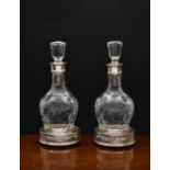 A pair of elegant Elizabeth II cut glass crystal decanters with silver collars, C J Vander Ltd,