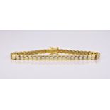 An 18ct yellow gold and diamond line bracelet, the brilliant cut diamonds in rubover settings, total