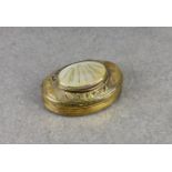 A 19th century brass snuff box with mother of pearl inset lid, of kidney shaped form, the top