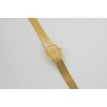 A ladies 18ct gold cased Omega wrist watch, with quartz movement, the oval champagne dial signed '