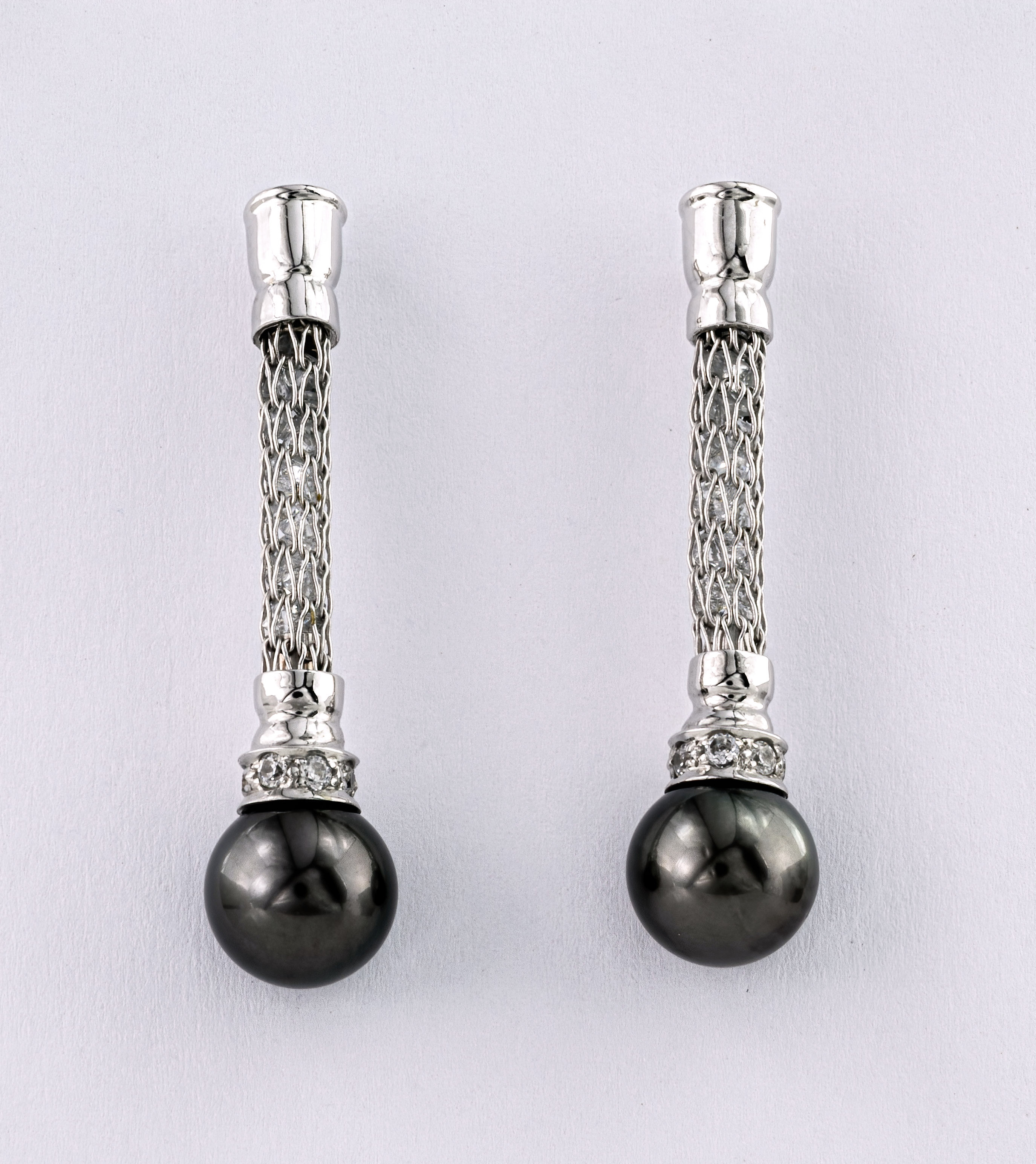 A pair of Na Hoku cubic zirconia and black pearl drop earrings, the cubic zirconium contained within