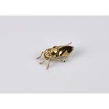 A small 9ct gold brooch in the form of a fly, 1920s-30, 16mm. long.