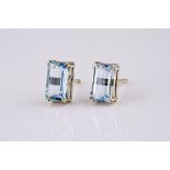 A pair of 18ct white gold and aquamarine stud earrings, each baguette cut aquamarine weighing