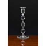 A 19th century cut glass candlestick, the panel cut urn sconce on an elliptical slice cut stem