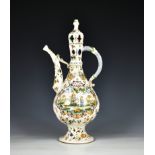 A faience lidded wine ewer of typical Islamic form, the tapered teardrop body with slightly flared