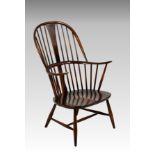 An Ercol comb-back double bow 'Chairmakers' Windsor armchair, with shaped seat, factory 'Reg. Des'