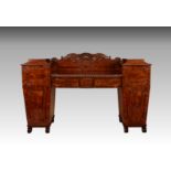 A late Regency mahogany double pedestal sideboard, the two tapered pedestals with pagoda tops and