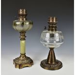 A Victorian gilt metal and alabaster oil lamp, the frosted glass reservoir painted with foliage