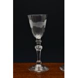 A mid-18th century light baluster engraved 'Friendship' wine glass, c.1750, the pointed round funnel