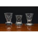 Three 19th century Masonic firing glasses, all with engraved square and compass motif, comprising