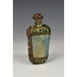 A Chinese Sino-Tibetan snuff bottle, having stone tapering body with metal mounts, having lion masks