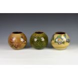 Three Guernsey pottery vases, each of globular form, one decorated with bird and flowers on