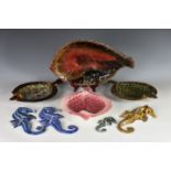 A collection of Guernsey Pottery fish plates/platters and seahorses, the largest in reds, browns and