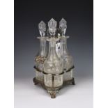 A Victorian silver plated three bottle decanter stand, the trefoil stand with foliate handle and