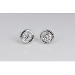 A pair of 18ct white gold and diamond ear studs, one 0.63ct VS2 diamond and one 0.6 SI1 diamond in