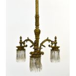 A French 19th century gilt bronze and cut glass three light electrolier, with twist and acanthus