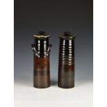 Two Guernsey pottery spaghetti storage jars, brown glazed, of similar tapering form, each printed 'C