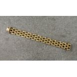 A 9ct yellow gold linked bracelet, with alternating rows of polished and hammered fancy links.