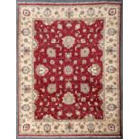 A large Indian Zeigler rug, fourth quarter 20th century, the madder field with central circular