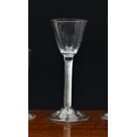 An elegant mid-18th century airtwist wine glass, c.1750, the pointed round funnel bowl on a