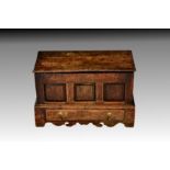 An early 18th century joined oak miniature mule chest, the hinged plank top with moulded front edge,