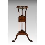 A George III mahogany wig stand, the dished, open top on ring turned supports over a central