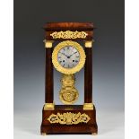 A French mahogany and ormolu four pillar portico clock, 19th century, with silvered Roman dial