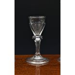 An unusual heavy baluster stemmed small wine glass, early 18th century, c.1730, the bowl with