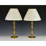 A pair of French gilt bronze candlesticks, 19th century, the urn form sconces on slightly tapered
