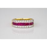 An 18ct gold, ruby and diamond ring, with 9 square cut rubies of approx 0.45ct total, set within a