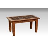 A rectangular hand carved hardwood coffee table, probably Moroccan, 20th century, the top with
