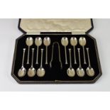 A set of twelve Art Deco silver teaspoons & sugar tongs in original fitted case, Cooper Brothers &