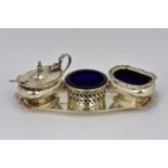 A trio of silver plate condiments and tray, a good match, each having cobalt blue liners. *