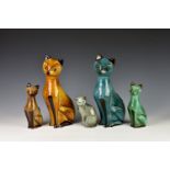 Four Guernsey Pottery seated Siamese cat figurines, of varying sizes and colourways, the tallest