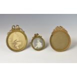 Three Victorian French gilt metal miniature easel back photo frames, of circular form, having