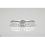 An 18ct white gold and diamond full eternity ring, channel set with twenty eight princess cut