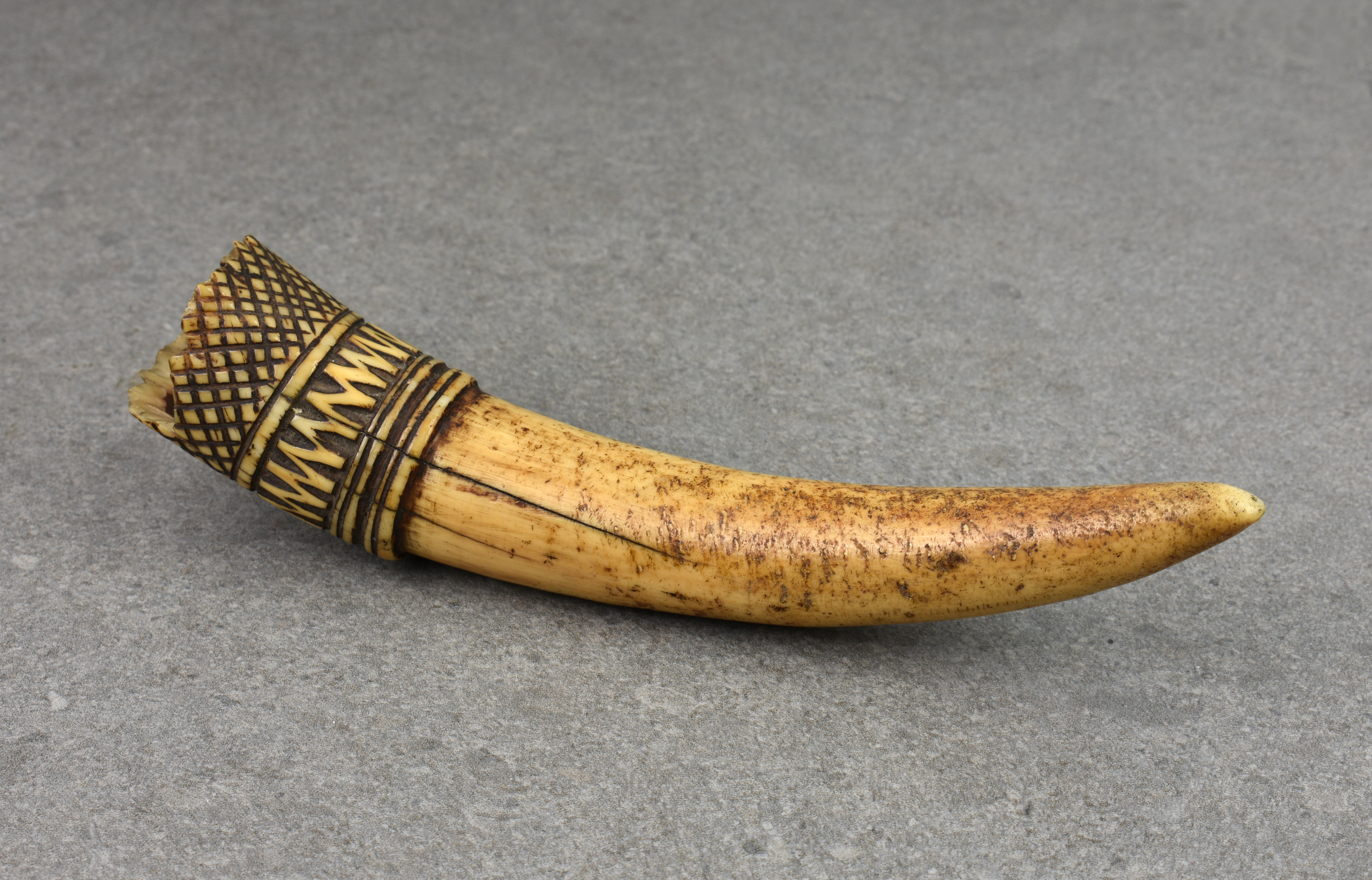 A 19th century or earlier carved African tribal tusk ornament, probably used hanging from a