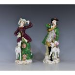 A pair of Continental figures of a huntsman and huntswoman, probably Samson, early 20th century,
