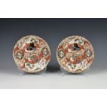 A pair of Chinese porcelain plates, 19th century, enamelled and painted with pairs of figures on