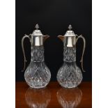 A pair of 20th century cut glass claret jugs, of bulbous form, having silver plated mounts, the
