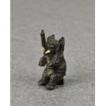 An Austrian miniature cold painted bronze of a comical seated elephant, probably early 20th century,