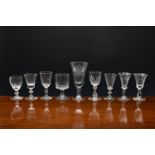 Seven 19th century small wine or gin glasses, with petal and panel cut decoration, 9.9cm. to 12.4cm.