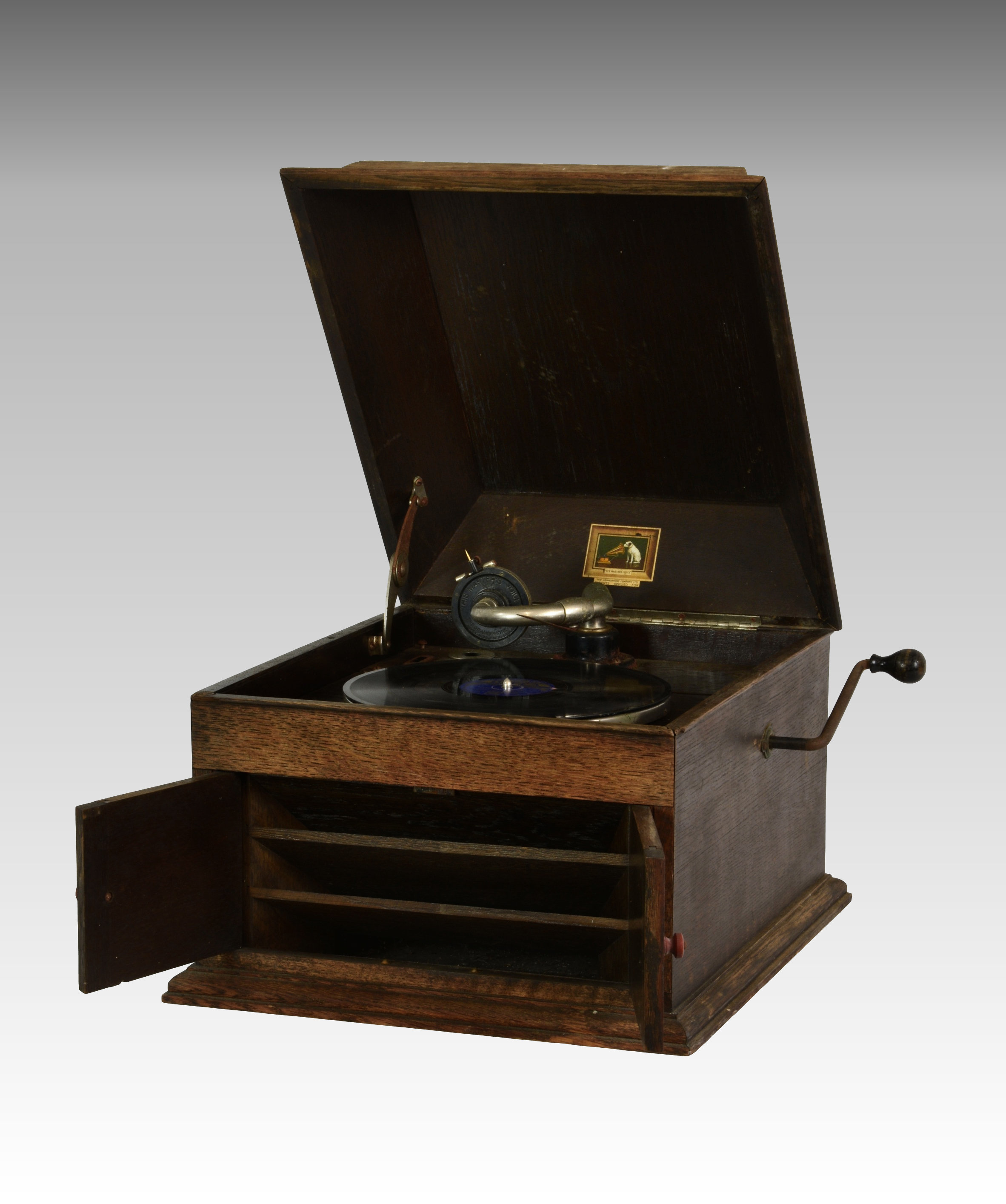 An oak cased ' His Masters Voice ' model 103 table-top gramophone, the hinged front doors opening to