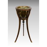 An Edwardian tulipwood and mahogany basket top jardiniere stand, with brass liner and swept tripod