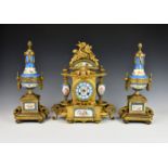A late 19th century French gilt metal and porcelain matched clock garniture, the architectural style