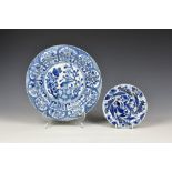 Two Chinese porcelain blue and white dishes, 17th century, the larger with moulded fluted