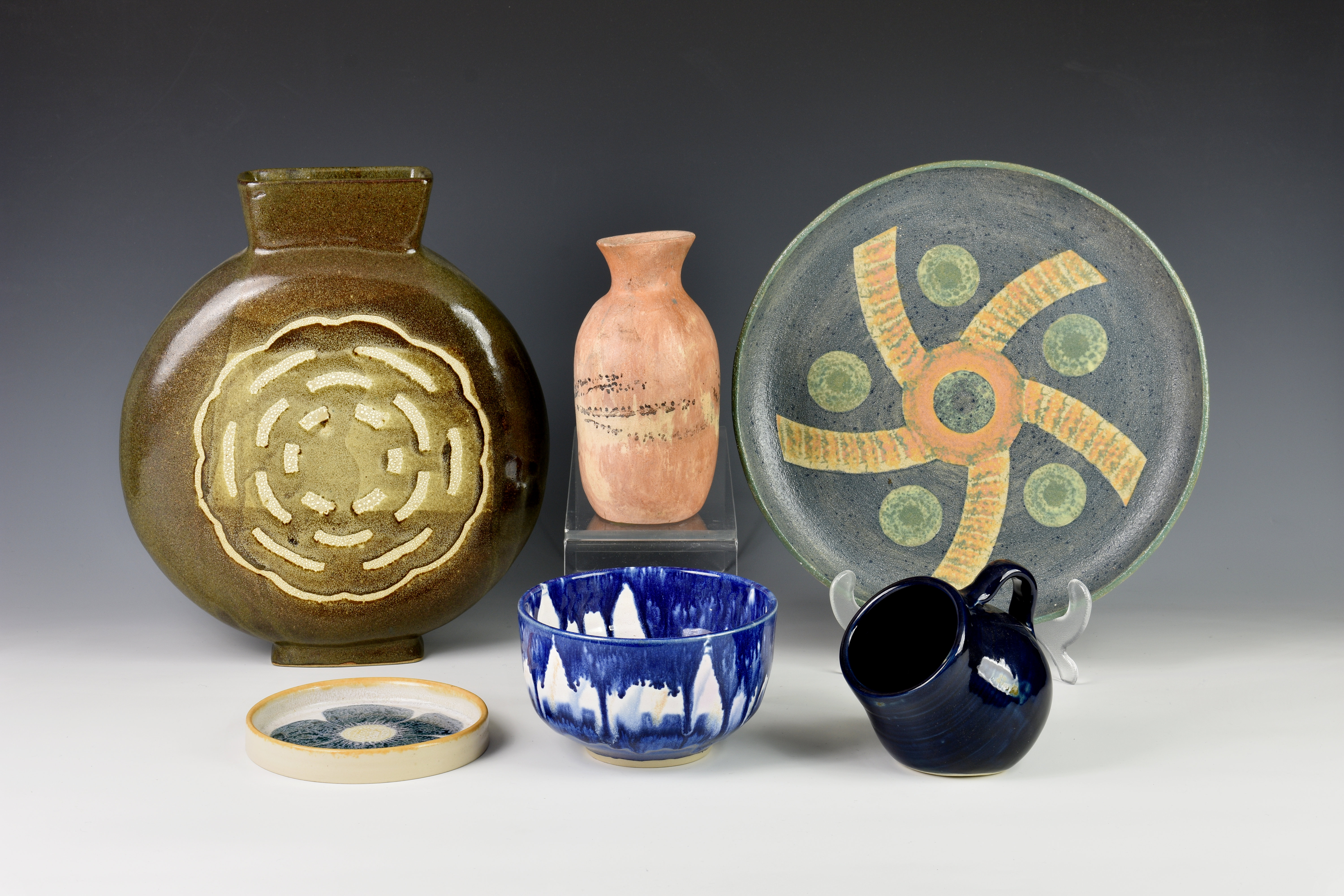 A collection of David Richards Guernsey Pottery, comprising a moon flask style vase with tapering