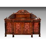 A William IV rosewood breakfront side cabinet, the serpentine arched back with a single shelf and