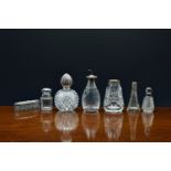 A Victorian spherical diamond cut glass scent bottle with silver collar and wrythen fluted top, John